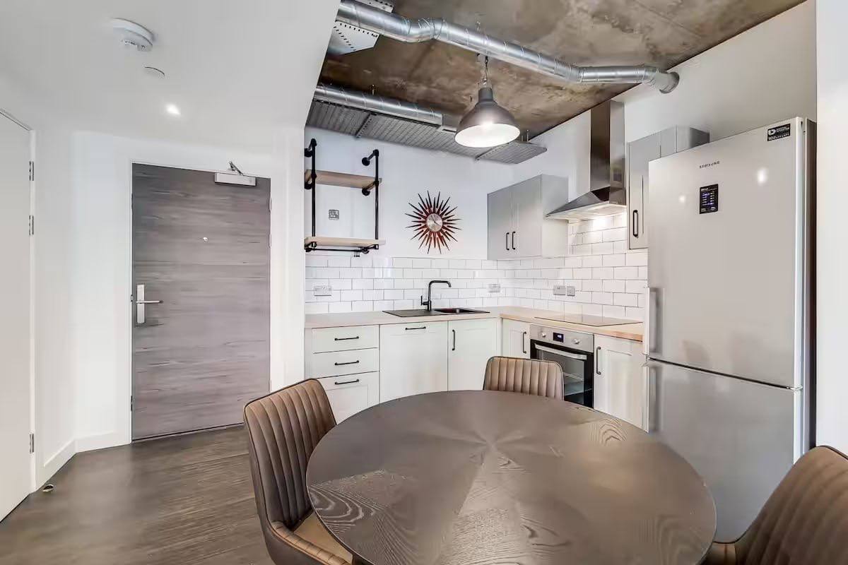 a kitchen with a table and chairs